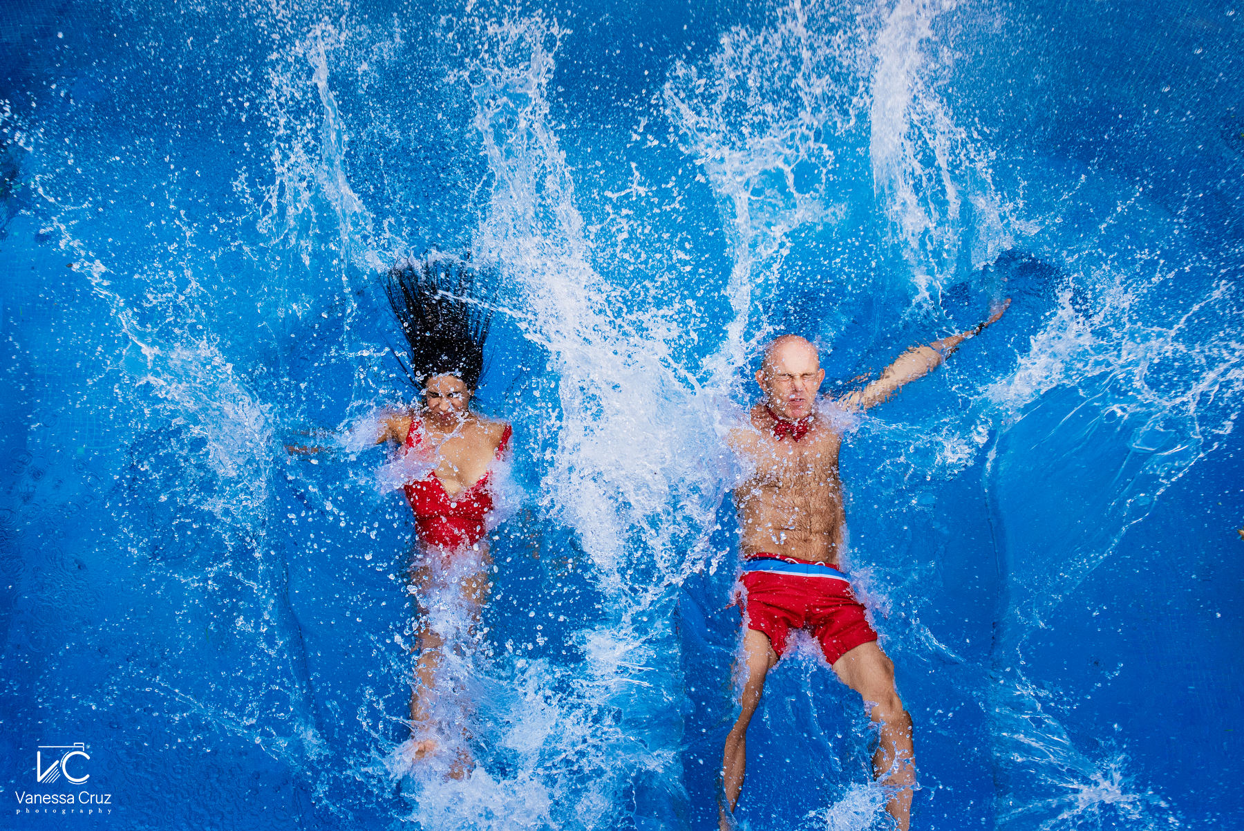anniversary couple celebrating with a splash in the pool
