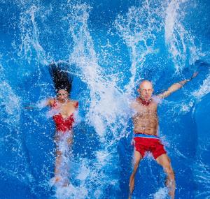 anniversary couple celebrating with a splash in the pool
