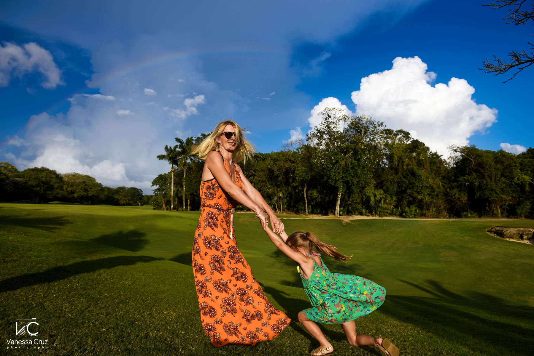 Mom and daughter playing around rainbow Playa del Carmen Mexico