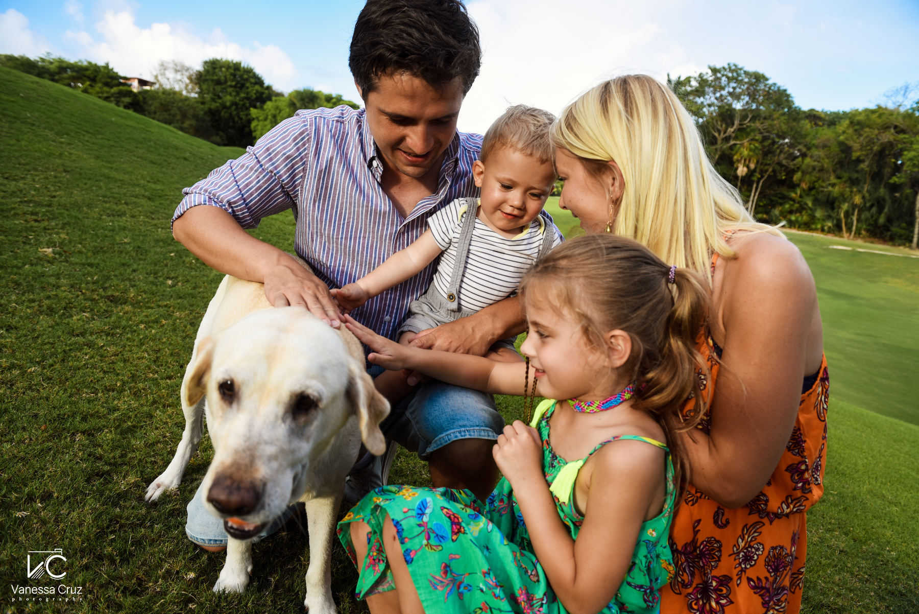 Family playing with dog at golf camp Playacar Playa del Carmen Mexico