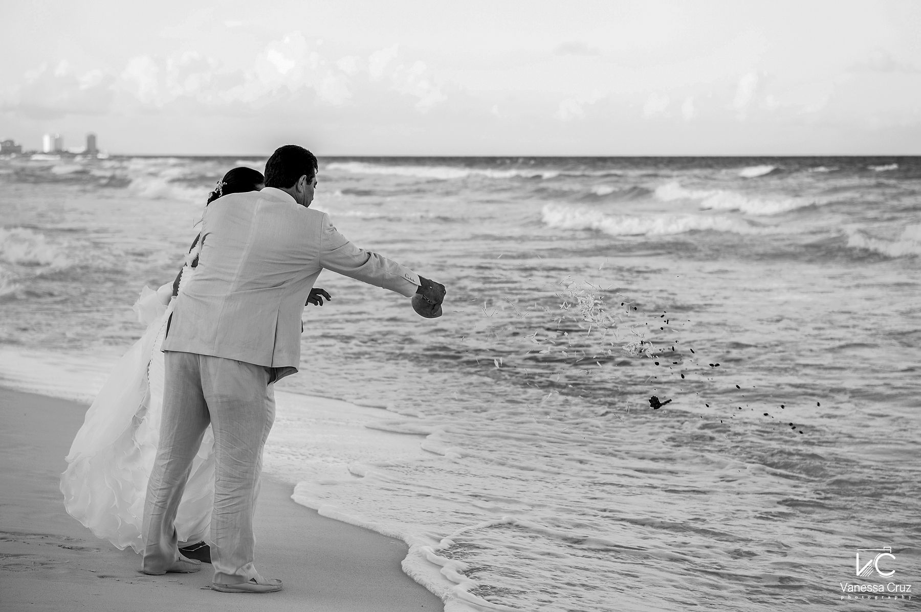 Bride and Groom offering seed to the sea Cancun Mexico